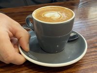 Hayes Common Coffee with hand